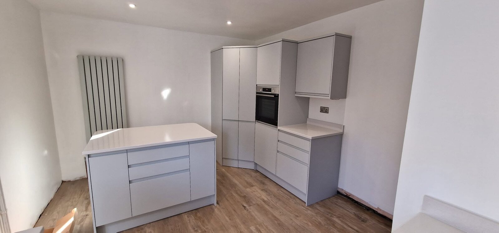 Howdens Clerkenwell Matt Dove Grey kitchen with island and LVT flooring