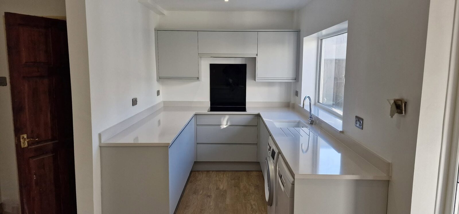 Completed Dove Grey kitchen with Aspen Crystal Quartz worktops and upstands
