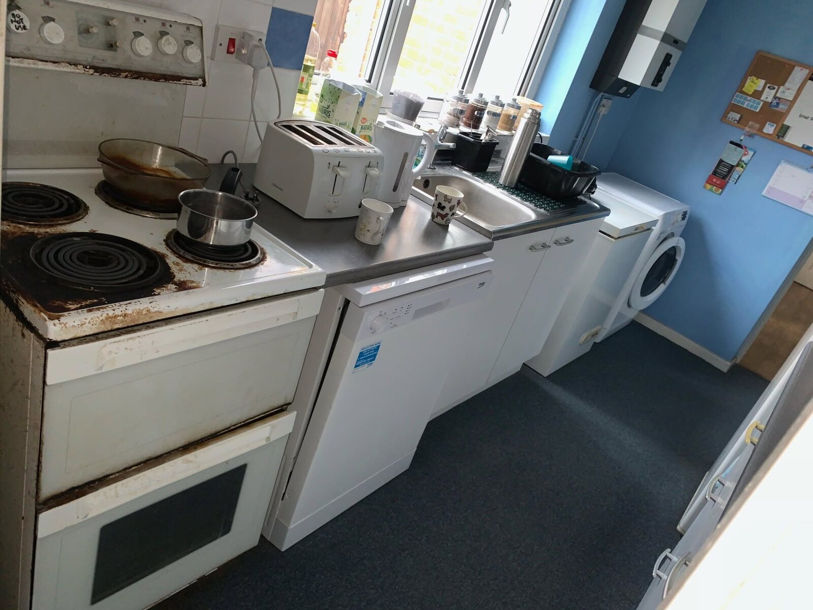Original compact kitchen before its Gloss Dove Grey transformation, cooking and sink area