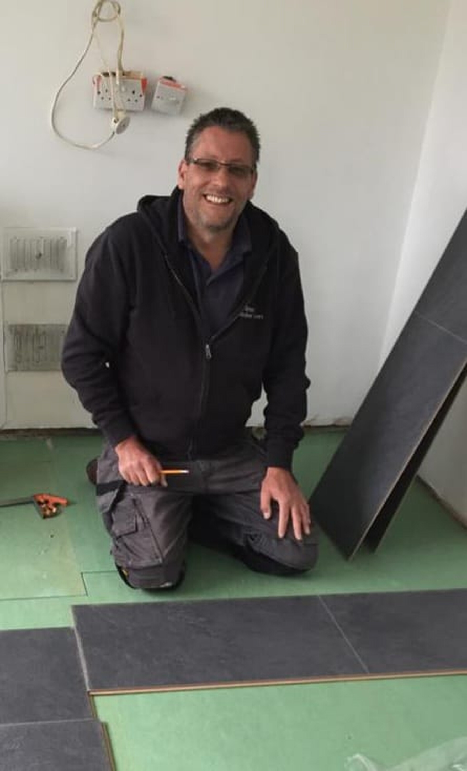 Tony from Stratton Kitchen Fitters installing kitchen flooring